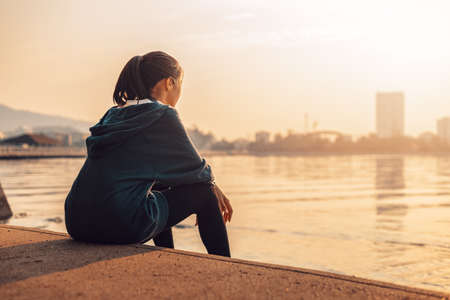 woman runner takes a break after jogging in the morining.の写真素材