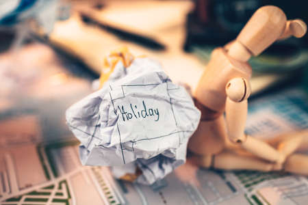 Crump paper calendar with the word holiday written on. Cancel and fail plan Travel, holiday, vocation and new year concept.の写真素材