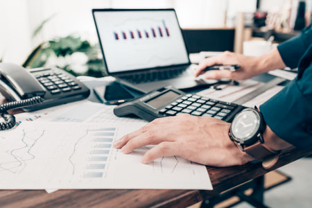 Businessman working on office desk and analyzing new project of accounting finance. Investment, Financial advisor and accounting concept.の写真素材