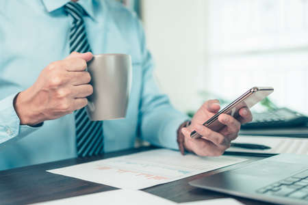 Businessman use cell phone and working on office desk and analyzing new project of accounting finance. Investment, Financial advisor and accounting concept.の写真素材