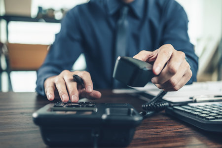 businessman dialing desk phone in the office. Telephone dialing ,contact and customer service.