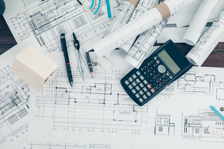 Mini model house, pencil, compass  and roll blueprint plan  on blueprint house plan design. Architect and engineer concept.の写真素材