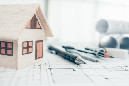 Mini model house, pencil, compass  and roll blueprint plan  on blueprint house plan design....