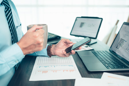 Businessman use cell phone and working on office desk and analyzing new project of accounting finance. Investment, Financial advisor and accounting concept.の写真素材