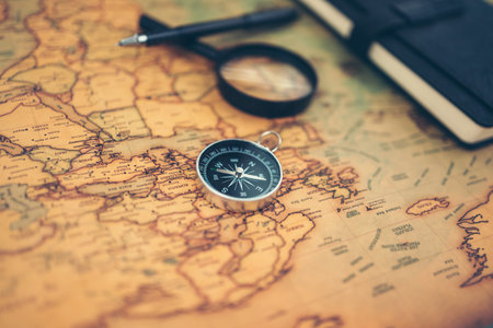 Magnetic compass, magnifying glass and diary on world map. Travel , Adventure and Discovery concept.