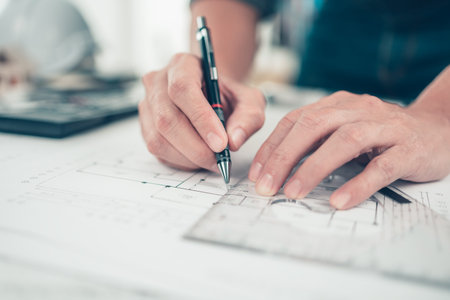 Architect engineer use pen and  triangular angle ruler  drawing design working on blueprint. House...