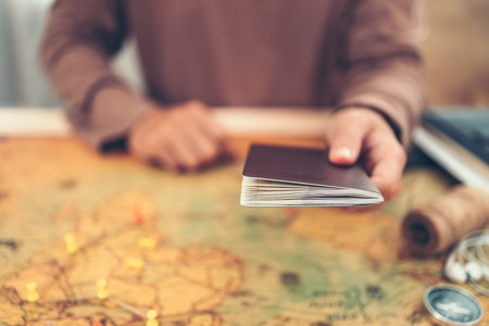 Hands showing passport above world map. Travel , Adventure and Discovery concept.の写真素材
