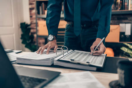 Investors working on desk office and finger  pointing to check tracking cost, balance, projit and  currency. Accounting and  Financial concept.の写真素材