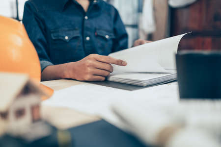 Architect engineer read drawing design working on blueprint. House planning design and construction concept.の写真素材