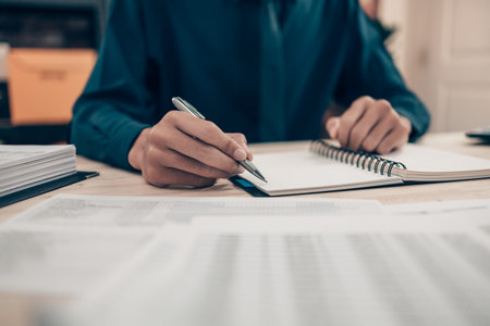 Investors working on desk office and using a pan and pointing to check tracking cost, balance,...