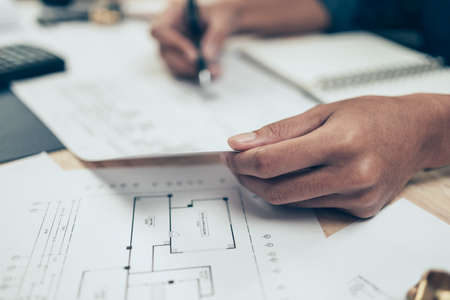 Architect engineer use pen  drawing design working on blueprint. House planning design and construction concept.の写真素材