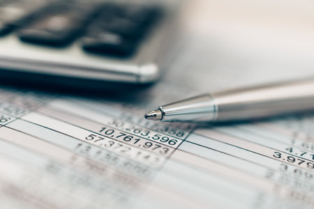 Pen and calculator on desk office. Object for calculator to calculate balance, projit, currency and cost. Accounting and  Financial concept.の写真素材