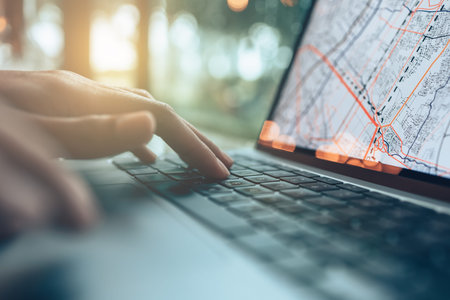 Travelers planning trips and use laptop to book hotels, buy plane tickets, search map, or find...