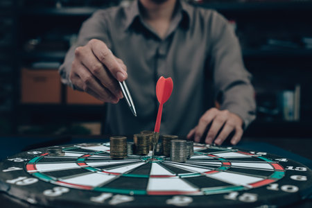 dart board has dart arrow hitting of a shooting target for business targeting and good success.の写真素材