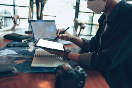 Travelers planning trips and use tablet to book hotels, buy plane tickets, search map, or find travel routes. Travel concept.の写真素材