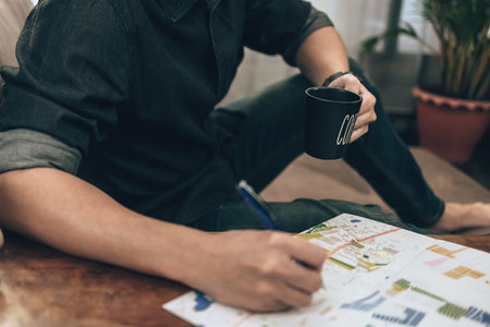 Travelers drink coffee while planning trips and writing pointing on map, or find travel routes....