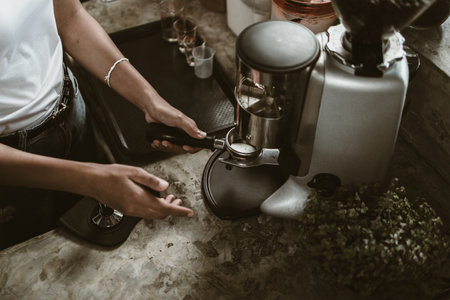barista use bottomless filter with grinder machine at coffee shop. coffee maker concept.の写真素材