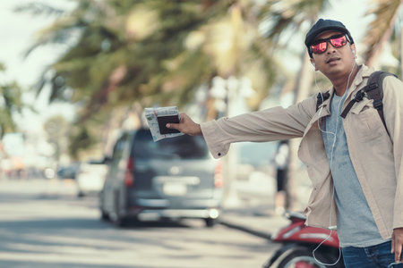 Tourists hold maps and hitchhiking. backpacker and travel concept.の写真素材