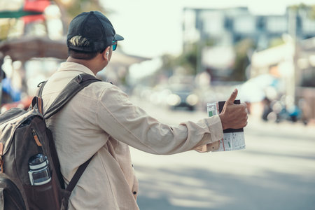 Tourists hold maps and hitchhiking. backpacker and travel concept.の写真素材