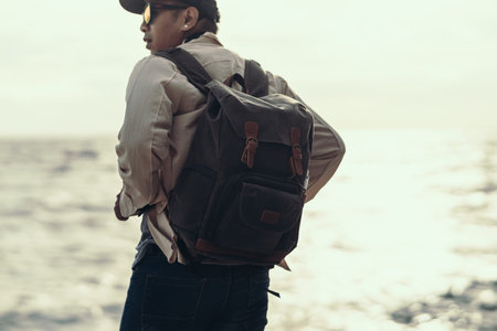 Tourists stand to watch sea sunset. backpacker, travel concept.の写真素材