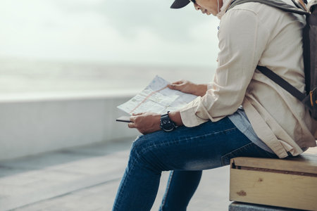 Tourists hold maps to find attractions, restaurants or hotels. backpacker and travel concept.