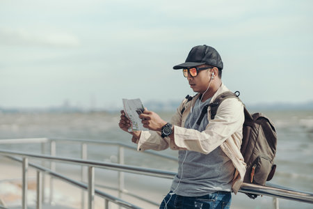 Tourists hold maps to find attractions, restaurants or hotels. backpacker and travel concept.の写真素材