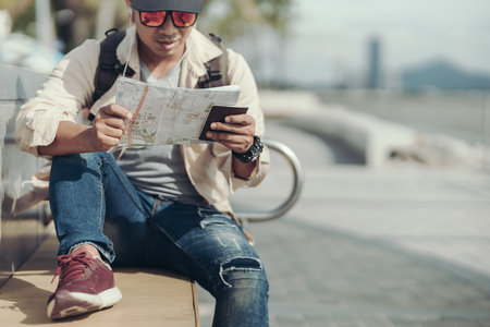 Tourists hold maps to find attractions, restaurants or hotels. backpacker and travel concept.