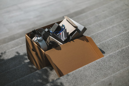 Cardbox of Employees fired or resigned on stairs. Unemployed, hiring job, quitting job concept.