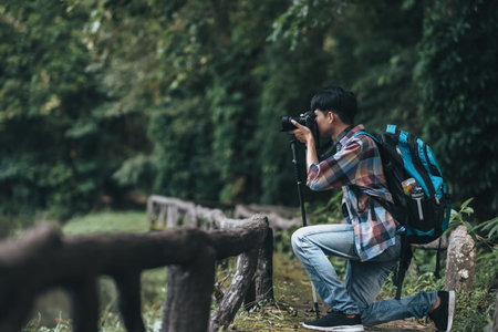Hikers  with backpacks use camera shooting lanscape in the forest. hiking and adventure concept.