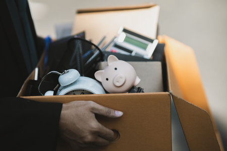 Businessman fired or resign from the company are carrying boxes down the street looking for a new...