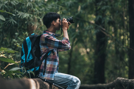Hikers  with backpacks use camera shooting lanscape in the forest. hiking and adventure concept.の写真素材