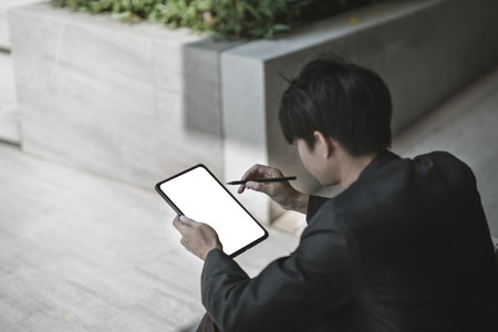 Employees fired or resigned from the company are using tablet to find a jobs.
Unemployed, hiring job, quitting job concept.の写真素材
