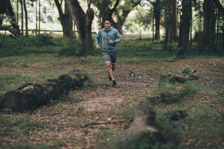 healthy lifestyle young fitness man running the forest. Outdoor workout,  Healthy lifestyle concept.の写真素材