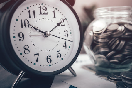 Alarm clock, Stack of money coin for saving money growing business, saving plan. Calculator, pen,...