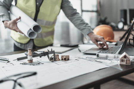 Engineering working with drawings inspection on the office desk  safety glasses, compass, vernier...