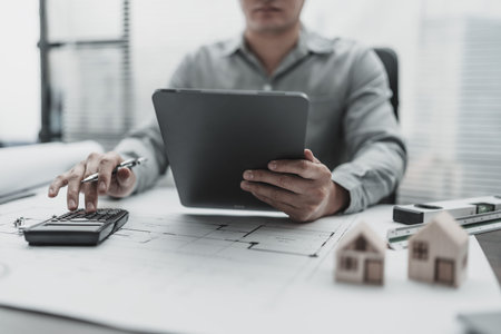 Architect, Engineering working with house drawings inspection on tablet in the office. Engineer,...