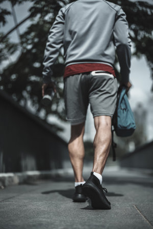 A man walking on footbridge in the city center park before cardio workout.  Health and Lifestyle in big city life concept.の写真素材
