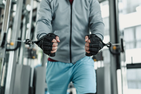 A man working On His Chest With Cable Crossover In Gym. Fitness, workout, sport and health concept.の写真素材