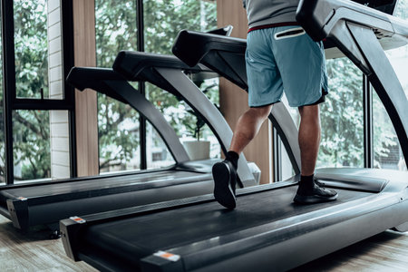 A man running on track treadmill, exercise fitness. Fitness, gym, workout and lifestyle concept.の写真素材