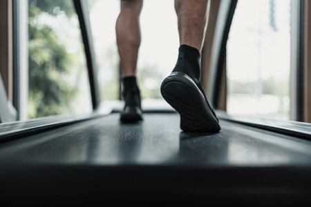 A man running on track treadmill, exercise fitness. Fitness, gym, workout and lifestyle concept.の写真素材