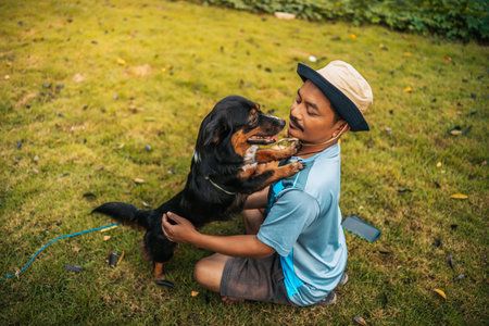 A man playing with a dog together on  grass. Pet, Family, Friendship concept.の写真素材
