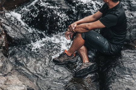 Hikers relax in the stream flowing from the waterfall. hiking concept.