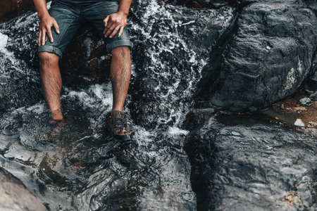 Hikers relax in the stream flowing from the waterfall. hiking concept.