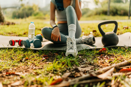 A woman dressed for exercise and sits on a yoga mat. Fitness, Workout and Yoga concept.の写真素材