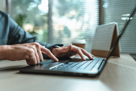 Businessman is hand working and typing on laptop. Business, corporate and finance concept.の写真素材