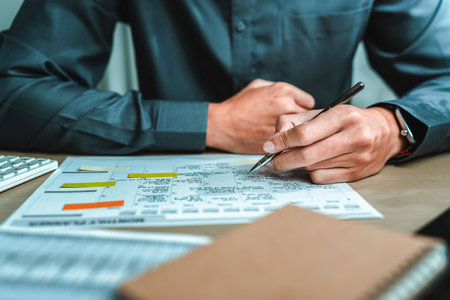 Businessman hand planning daily appointment and note at office desk. Planner plan Schedule Calendar and reminder. Business planning appointment concept.の写真素材