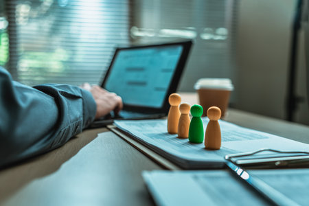The wooden doll represents the employee of the company line up on business document in workplace and them represents new employee, search job or job career. Corporation, Enterprise concept.の写真素材
