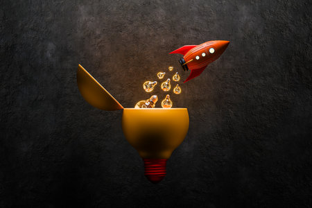 A rocket launching with a light bulb bursting out represents ideas, thoughts, planning, goals, and success.の写真素材