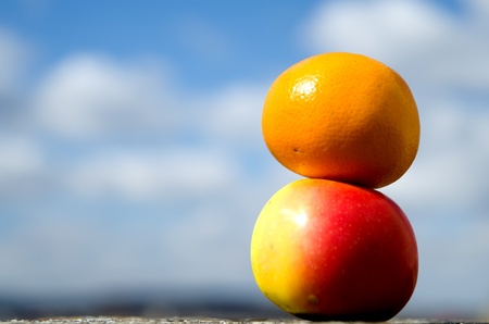 Mandarin with apple, sky background の写真素材