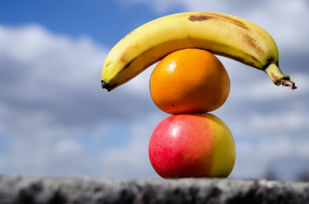 Fruits  apples, mandarin and banana, sky background の写真素材